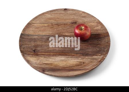 Red ripe apple on a large wooden platter Stock Photo