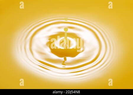 drop falling on orange juice Stock Photo