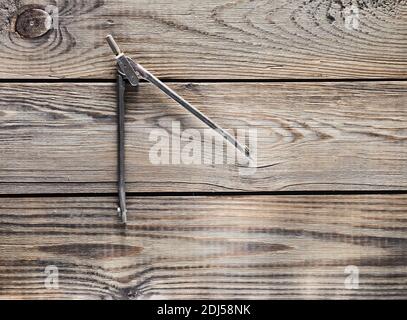 Metal compasses on a wooden table. Stock Photo