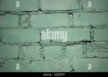 Painted into teal green Brick wall background closeup. Stock Photo