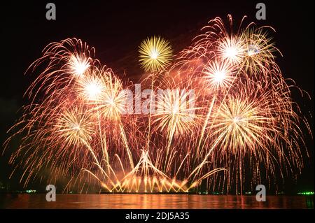 Blurred Colorful holiday fireworks in the night sky on a holiday festival night Stock Photo