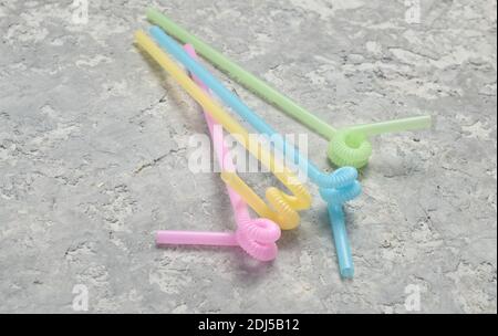 Colored pastel cocktail tubes on a gray concrete surface. Stock Photo