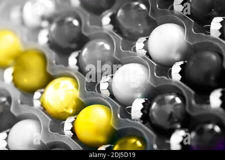 Closeup set of colorful rounded decorated Christmas balls in plastic transparent container Stock Photo
