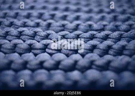 blue background large knitted thread pattern. Stock Photo