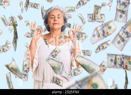 Senior woman with gray hair wearing bohemian style relaxed and smiling with eyes closed doing meditation gesture with fingers. yoga concept. Stock Photo