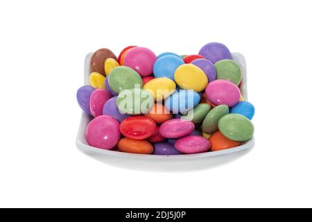 A bowl of colourful sugar coated chocolate candies - white background Stock Photo