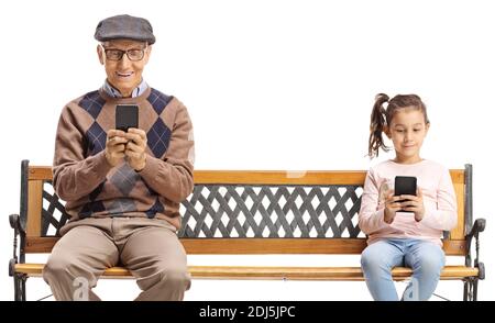 Elderly man and a child sitting on a bench and using smartphones isolated on white background Stock Photo