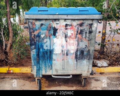 Colorful graffiti on a grey rubbish bin on a street, Athens, Greece Stock Photo