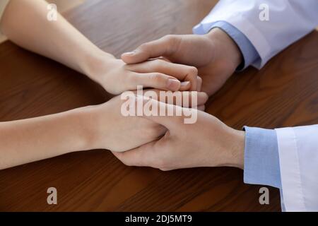Close up of male doctor hold patient hands Stock Photo