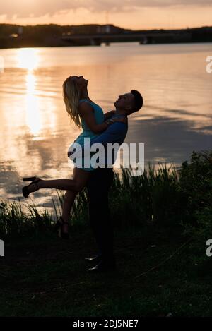 Silouette, loving couple on the lake during sunset Stock Photo