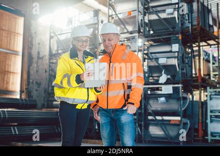 Workers checking inventory of warehouse Stock Photo