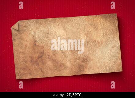 Vintage paper on red background. Grunge paper texture on old background. Old paper banner on red cardboard. Stock Photo
