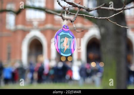 Christmas ball decorated with lightning - Women Strike symbol hangs on tree in front of university building during demonstration 13.12.2020 Stock Photo