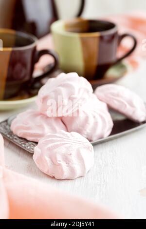 Russian Strawberries with cream marshmallows and tea on a bright table. still life, selective focus. vertical Stock Photo