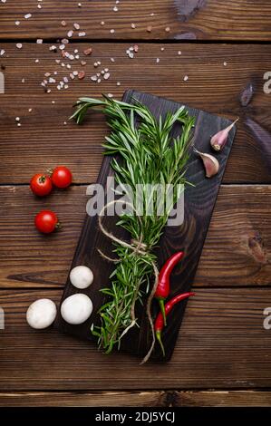 Fresh vegetables on board, wooden background Stock Photo