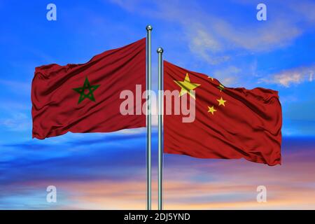 Flag of Morocco and China waving together in the blue sky Stock Photo
