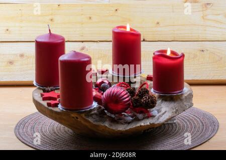 Red burning candles on an Advent arrangement. It is the third Advent. Christmas is coming soon. Stock Photo