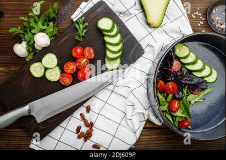 Fresh cutted vegetables, wooden background Stock Photo