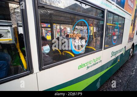 Double decker bus in Manchester, England UK during coronavirus pandemic December 2020. Passengers wear face masks Stock Photo