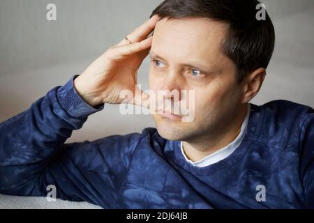 Portrait of a man with a pensive expression on his face. Close-up shot. Stock Photo