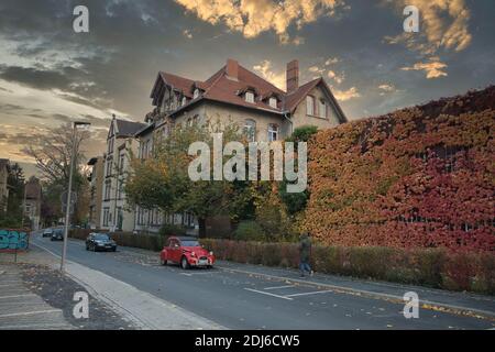 Göttingen, Germany. Obere Karspüle street with ivy covered wall in autumn. Wide shot. Stock Photo