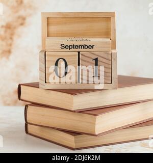 Wooden calendar September 1 on a stack of books. Concept for Knowledge Day, beginning of school year.  Stock Photo