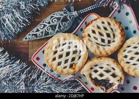 Christmas platter of fruit mince pies with festive decoration Stock Photo