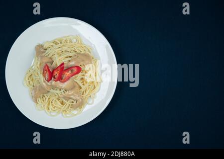 Pesto penne pasta dish on a black background Stock Photo