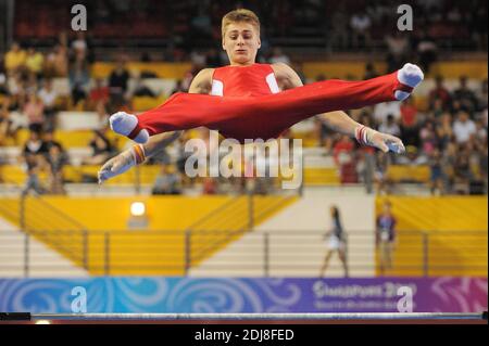 2010-08-22. Robert Tvorogal of Lithuania competes in the 2010 Singapore Youth Olympic Games Men's Horizontal Bar Finals. Stock Photo