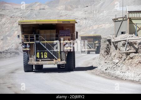 Huge dump trucks working the Chuquicamata open pit copper mine, the world’s largest by volume, Chile. Stock Photo