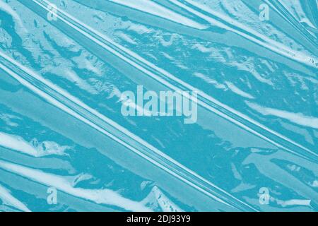 Wrinkled cling film, plastic texture, vinyl background. Blue abstract backdrop. Stock Photo