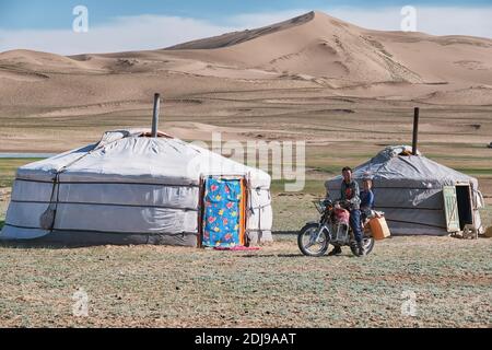 WESTERN MONGOLIA, - JUNE 2019: Mongolian nomadic traditional yurt. Camp in the border of the sandy desert. Mongol-Els, Western Mongolia. Stock Photo