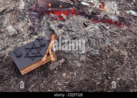 Mystical concept with voodoo objects, book and straw doll, esoteric, gothic and occult background. Stock Photo