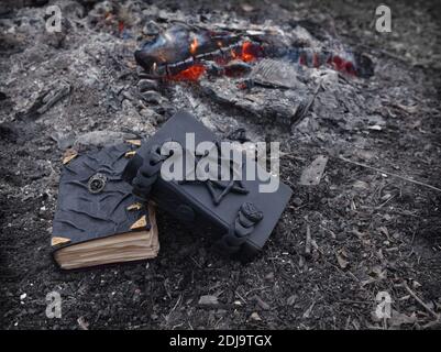 Mystical concept with voodoo objects, book and straw doll, esoteric, gothic and occult background. Stock Photo