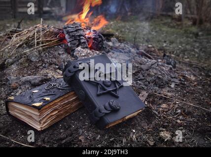 Mystical concept with voodoo objects, book and straw doll, esoteric, gothic and occult background. Stock Photo