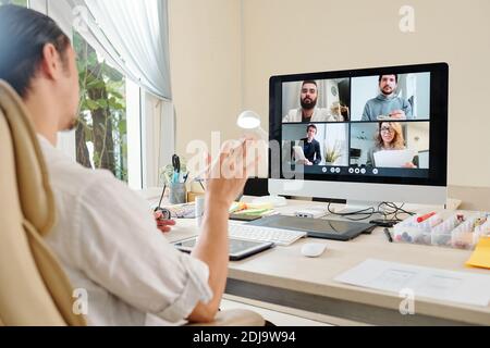 Graphic designer having online meeting with marketing team when working from home due to coronavirus pandemic Stock Photo