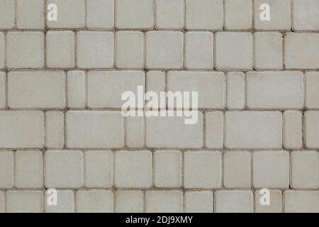 Concrete or cobble gray square pavement slabs or stones for floor, wall or path. Traditional fence, court, backyard or road paving. Stock Photo