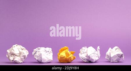 Colorful crumpled paper balls on a purple studio background, creativity or diversity concept, great ideas, teamwork Stock Photo