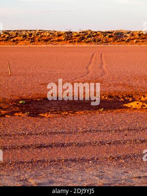 Wheel tracks across a dry claypan along the William Creek - Coober Pedy road, South Australia Stock Photo