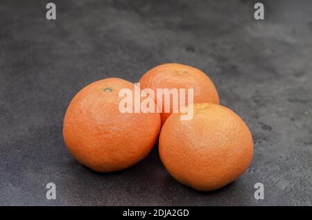 Close-up of  three fresh oranges on the table Stock Photo