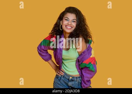 Pretty dark-haired young girl in bright jacket making poses Stock Photo