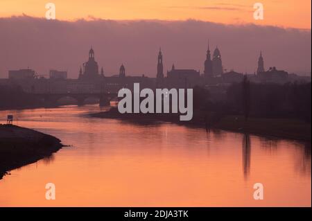 Dresden, Germany. 14th Dec, 2020. The backdrop of Dresden's old town with the Frauenkirche (l-r), the Ständehaus, the Katholische Hofkirche, the Hausmannsturm, the Rathaus tower and the Kreuzkirche at sunrise. Credit: Sebastian Kahnert/dpa-Zentralbild/dpa/Alamy Live News Stock Photo