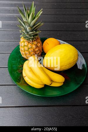 Assortment of fresh exotic fruits on  black table Stock Photo