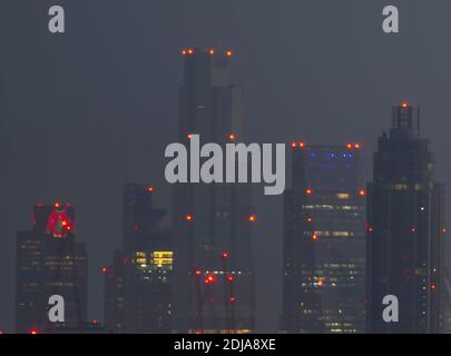 London, UK. 14 December 2020. City of London skyscraper illuminated before sunrise with christmas lights at Tower 42, previously the NatWest Tower (left), wearing a seasonal wooly jumper. Credit: Malcolm Park/Alamy Stock Photo