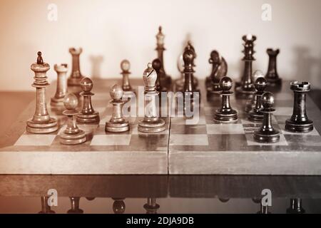 Chess game. Old wooden chess set on a polished table Stock Photo