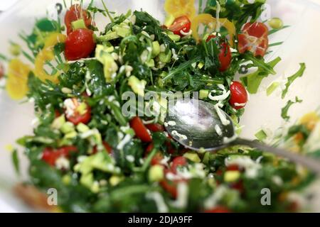 Salad with vegetables and arugula on plate Stock Photo