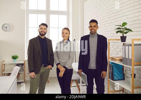Portrait of happy young colleagues, company trainees, managers or business partners Stock Photo