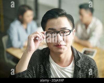 young asian small business entrepreneur looking at camera smiling Stock Photo