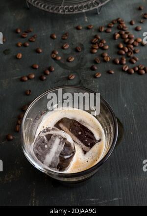 Ice cubes in tray and coffee beans on grey table, closeup Stock Photo -  Alamy
