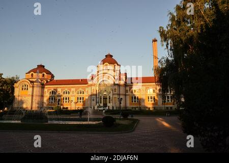 13.08.2018. Sofia. Bulgaria. Sofia Central Mineral Baths during sunset. Half ot the building in shadow others are lights coming from sunset. Stock Photo